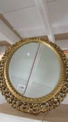 An oval gilt framed mirror, 49 x 33 cm.