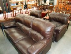 A brown suite comprising 3 seater settee,