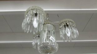 A 3 lamp glass chandelier.