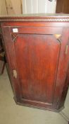 A Victorian oak corner cupboard with key.