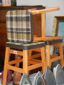 Three kitchen stools with fabric covered seats.