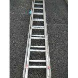 An double ladder with wooden sides and aluminium treads.
