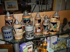 Twelve assorted beer steins.