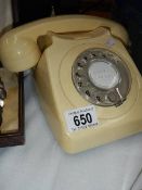 A vintage cream dial telephone.