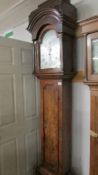 A George Lumley 8 day two train walnut long case clock with one piece silvered arch dial,