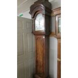 A George Lumley 8 day two train walnut long case clock with one piece silvered arch dial,