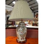An oriental style ceramic table lamp complete with shade.