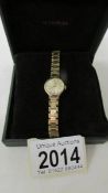 A 9ct gold backed Accurist 21 jewel ladies wrist watch on a yellow metal bracelet