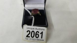 A 9ct gold ring set large red stone (ruby?), size O.
