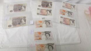 Ten UK ten pound notes of various ages.