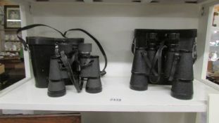 A cased pair of Royal 7 x 50 binoculars and a cased pair of Scope Executive 8.5 x 40 binoculars.