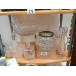 A shelf of good cut glass items.