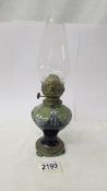 A small Royal Doulton oil lamp with chimney, 17 cm to top of burner, 27 cm to top of chimney.