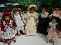 Five porcelain collector's dolls.