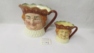 A large Royal Doulton Old King Cole character jug and a smaller example,