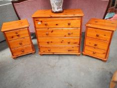 A pine chest of drawer with a pair of matching bedside chests.