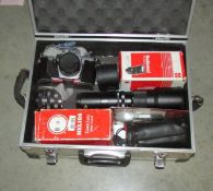 An aluminium case containing a Praktika camera, lenses etc.
