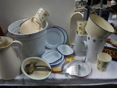 A mixed lot of vintage and modern enamel kitchen ware.