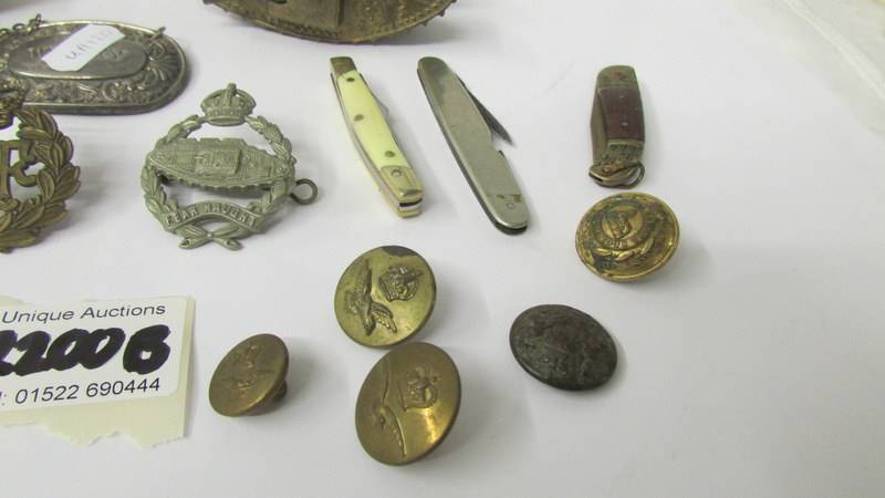 A mixed lot including 2 brass tanks, military badges, buttons, pen knives etc. - Image 3 of 4