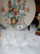 A cut glass decanter and 6 glasses.
