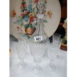 A cut glass decanter and 6 glasses.