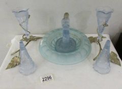 A blue glass rose bowl with central figure.