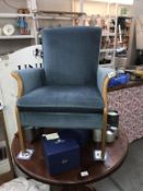 A blue fabric covered arm chair