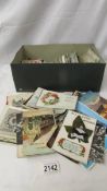 A box of vintage postcards, photographs, cigarette cards and silks etc.