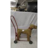 A vintage push along toy dog.