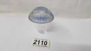 An irridescent glass mushroom paperweight with raised frog and lillies on top, signed P. S.