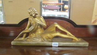 A signed art deco figure of a lady with a pheasant, signed S Modani.