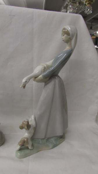 Three Lladro figures - Girl with goose and dog, girl with kittens and girl with bird. - Image 2 of 4