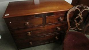 A mahogany 2 over 2 chest of drawers.