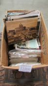 A large box of assorted postcards.