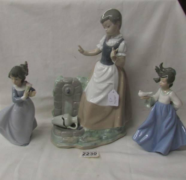 3 NAO figurines - A girl at a pump, a girl with a bird and a girl with flowers.