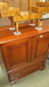 A solid medium oak 2 door cupboard with drop down front panel (locked and not key) no back in