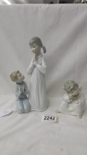 Two Lladro figurines - boy and girl praying and and angel.