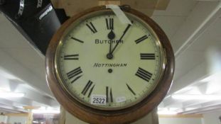 A circular wall clock marked Butcher, Nottingham.