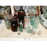 A collection of brown/clear bottles with a large chemist poison bottle