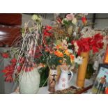 A large lot of artificial flowers in vases.