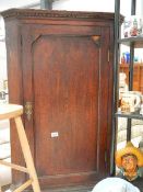 An oak corner cupboard.