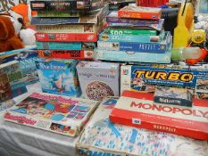 A quantity of old and later jigsaw puzzles, games etc.