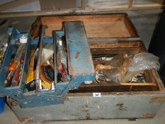 A large wooden box and a tool box full of tools.