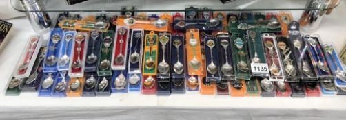In excess of 60 souvenir spoons including enamel examples.