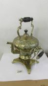 A 19th century brass kettle on stand.