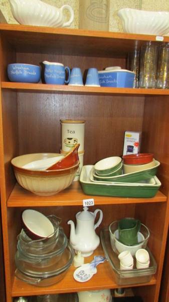 Seven shelves of kitchen ware including Pyrex.