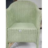 A green Lloyd Loom chair.