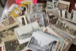 A box of assorted vintage postcards.