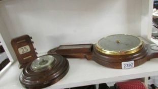 A mid 20th century Smith's barometer, another barometer and a perpetual calendar.
