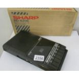 A boxed Sharp Rd. 620E Cassette recorder.